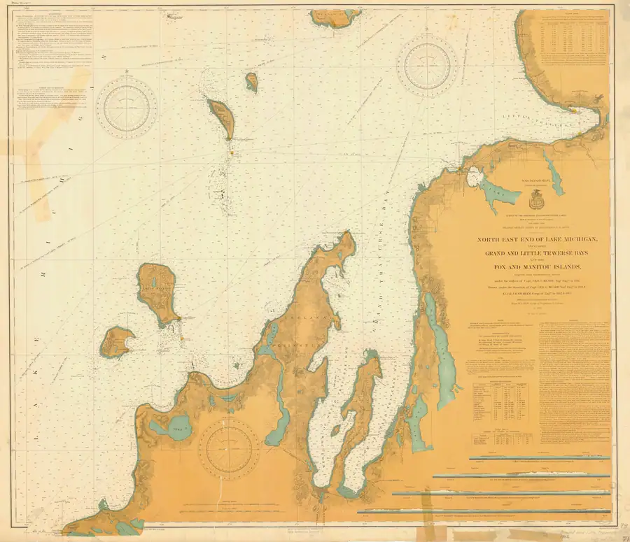 Nautical chart showing coastlines, islands, bays, soundings, compass roses, and navigational notes.
