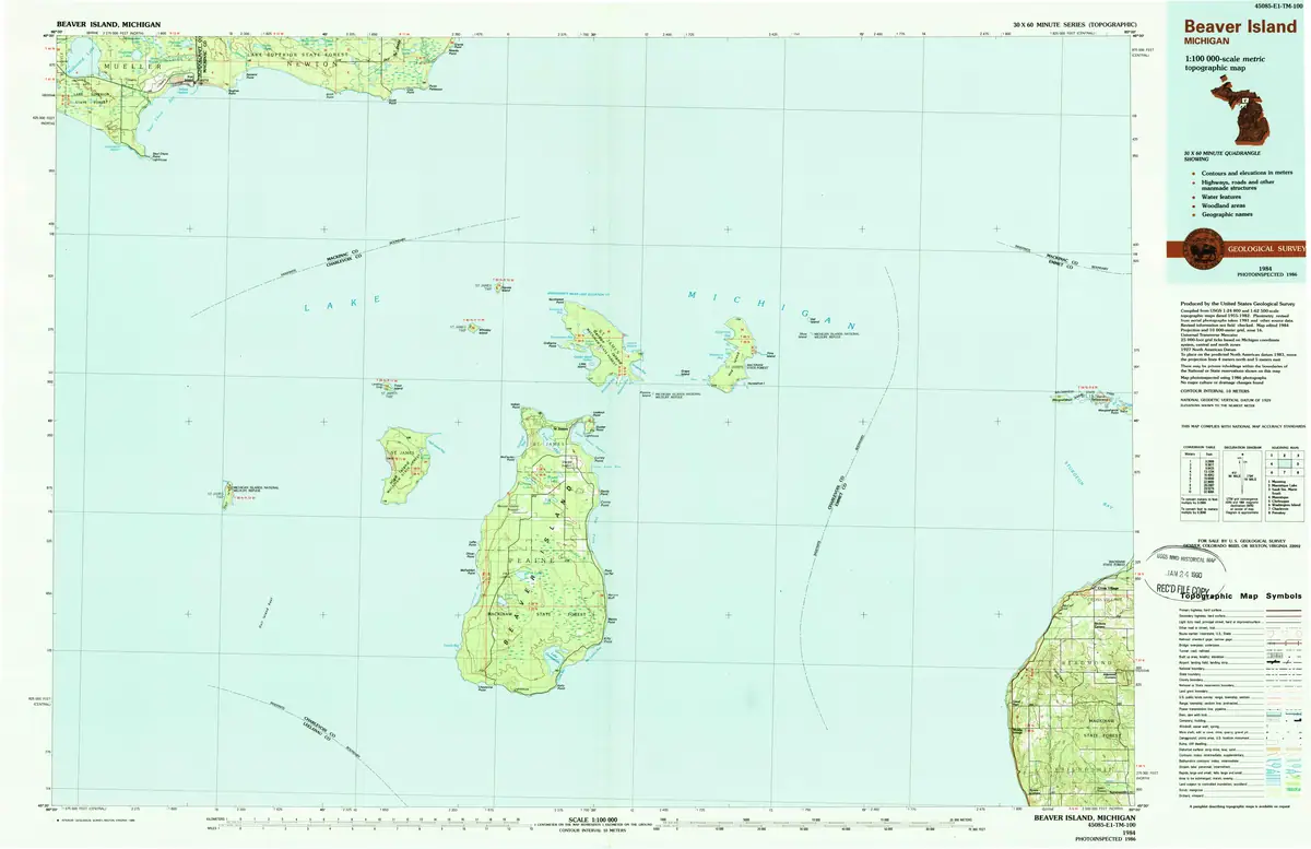 Colored topographic map showing green land areas, blue water, coordinate grids, and a map legend.