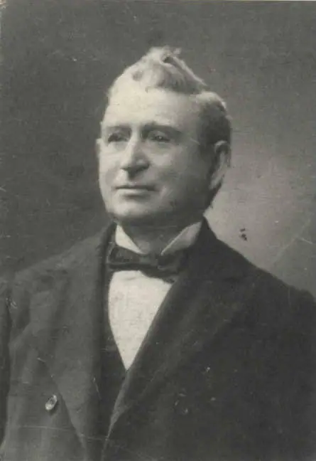 Black-and-white portrait of a man in a dark suit, white shirt, and bow tie.