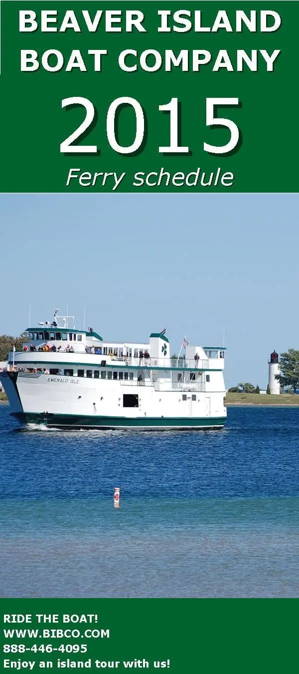 A white passenger ferry named EMERALD ISLE passes a lighthouse beneath a green ferry-schedule advertisement.
