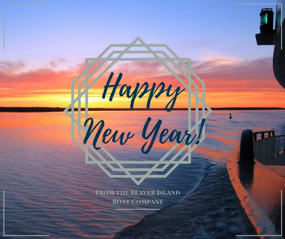 Sunset over calm water with a boat deck, buoy, and a New Year greeting overlay.
