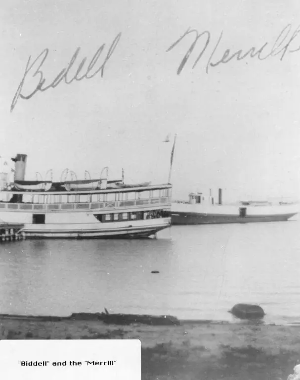 Black-and-white photograph of two passenger vessels beside a pier, with handwritten names above them.