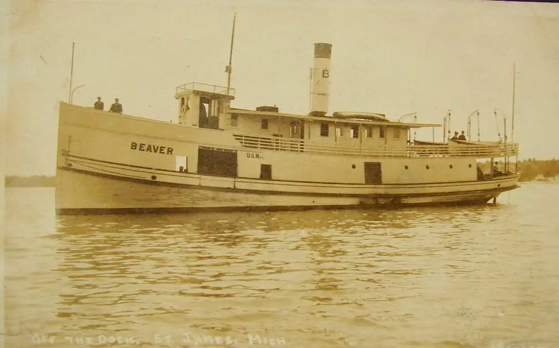 Sepia photograph of the steamship Beaver underway, with visible hull lettering and people on deck.