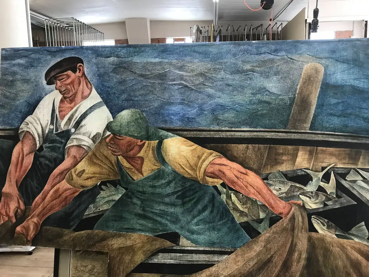 Photograph of a painted scene showing two fishermen handling fish in a wooden boat on rough water.