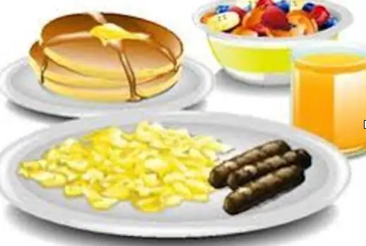 Illustration of pancakes, scrambled eggs, sausages, fruit salad, and orange juice arranged on a breakfast table.