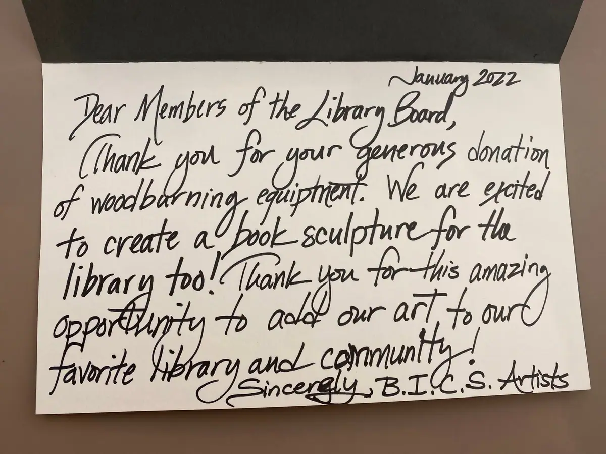 A handwritten thank-you note about donated woodburning equipment and a planned book sculpture.