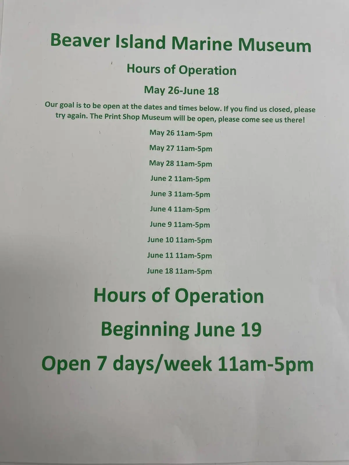 Photograph of a printed museum hours notice listing seasonal opening dates and daily hours.