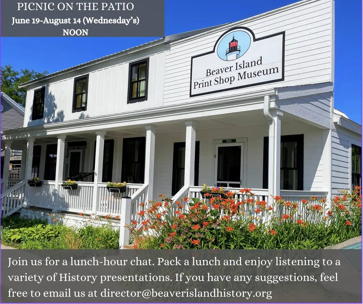 White two-story building with a covered porch, flower garden, lighthouse sign, and event text overlay.