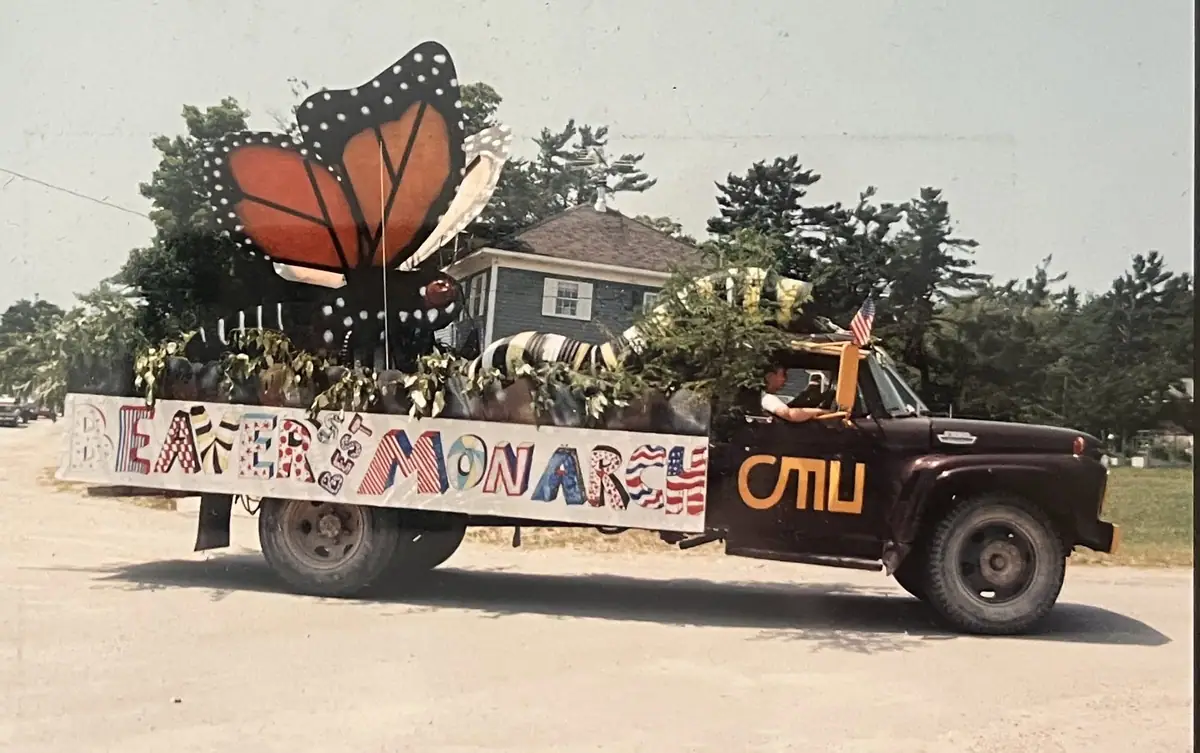 Decorated pickup truck carrying a large butterfly float and displaying “BEEKER'S BEST MONARCH.”