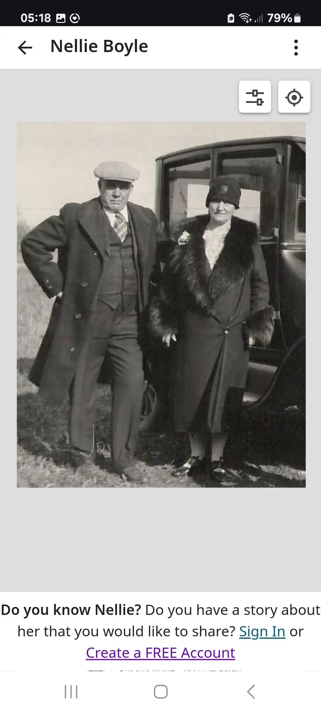 A screenshot displays a black-and-white photograph of two adults standing beside an automobile.