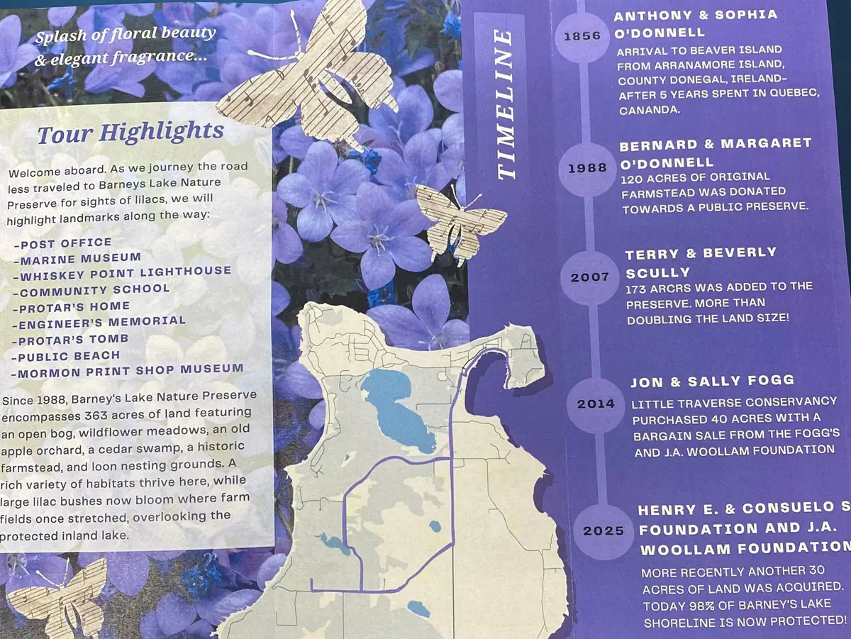 Close-up photograph of a floral brochure page with a preserve map, tour highlights, and a conservation timeline.