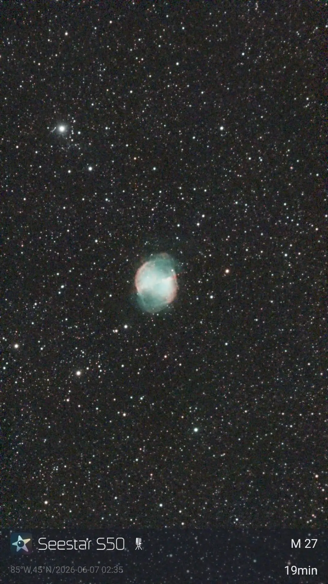 A star-filled night sky with a glowing turquoise and reddish nebula near the lower center.