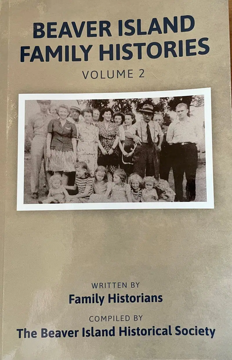 Photographed book cover with a black-and-white group portrait and large blue title lettering.